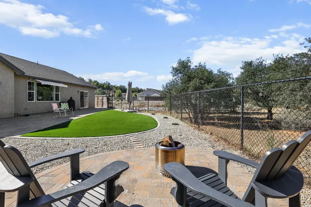 a view of a house with backyard and patio
