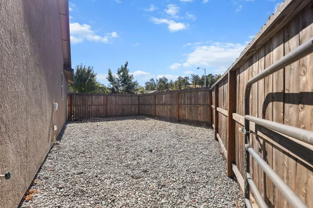 an aerial view of a house with yard swimming pool and mountain view