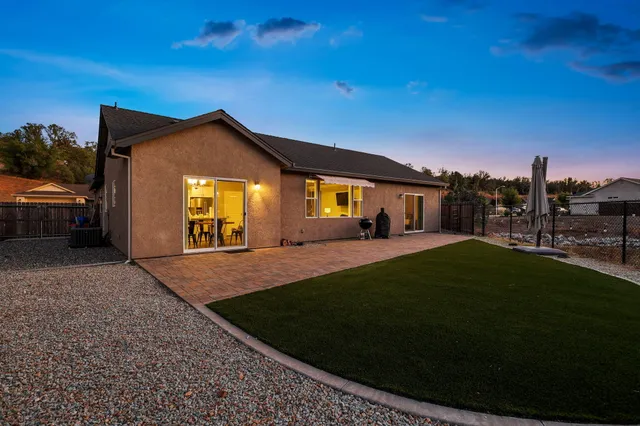 an aerial view of a house with a yard basket ball court and outdoor seating