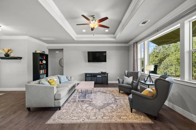 a living room with furniture and kitchen view