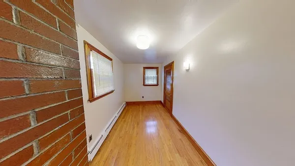 a view of bathroom with wooden floor and window