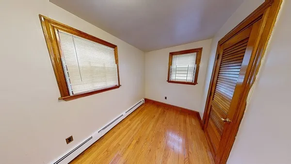 a view of a room with wooden floor and windows
