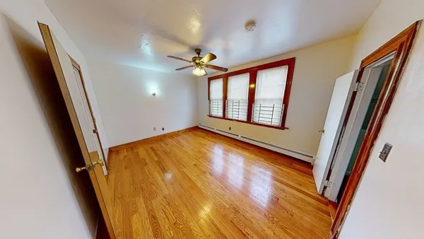 wooden floor in an empty room with a window