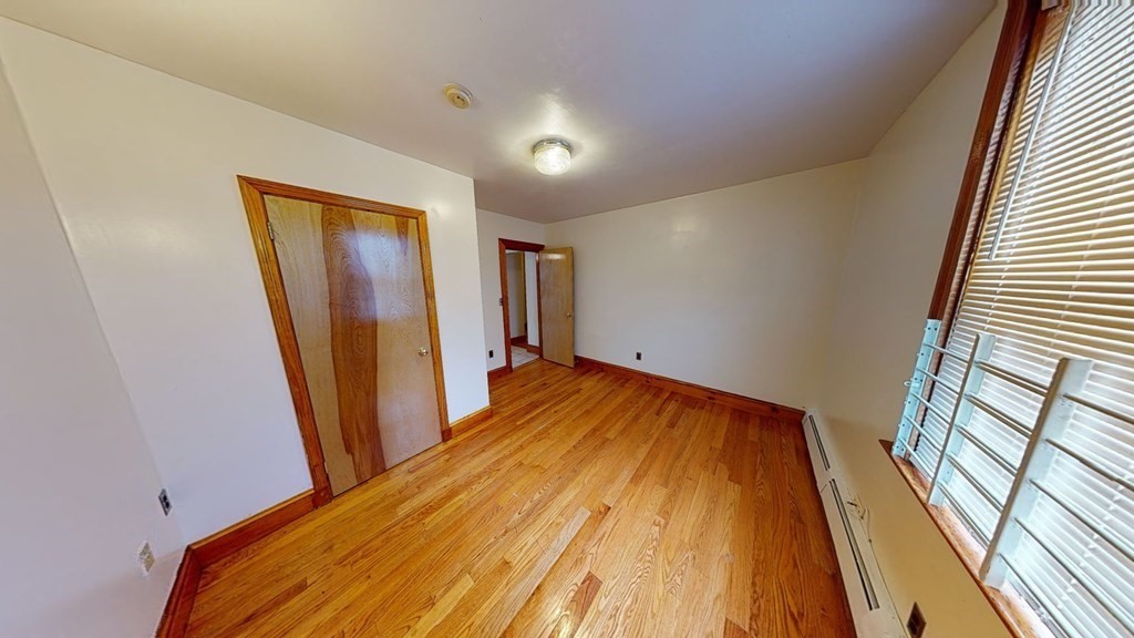 1 Normandy Street, Unit 3 Boston, MA 02121 - Photo 19 of 33 a view of a hallway with wooden floor