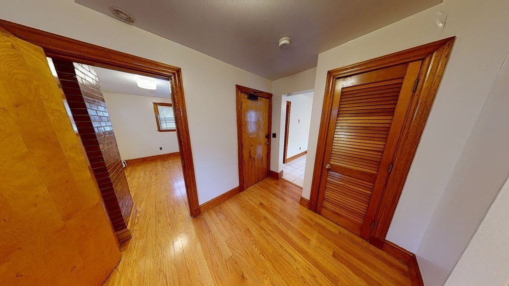 1 Normandy Street, Unit 3 Boston, MA 02121 - Photo 23 of 33 a view of a hallway with wooden floor and stairs