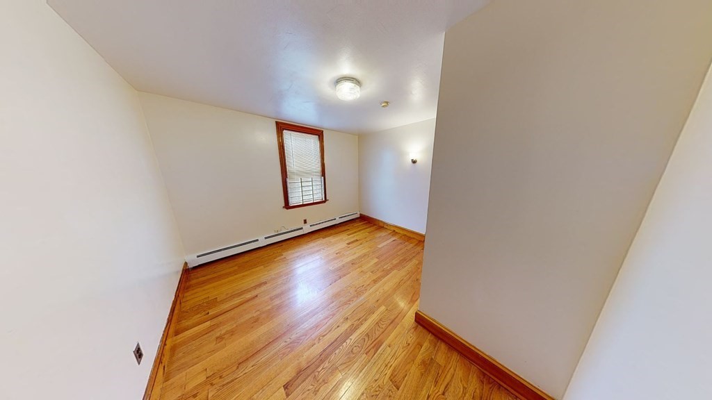1 Normandy Street, Unit 3 Boston, MA 02121 - Photo 26 of 33 a view of empty room with wooden floor and fan