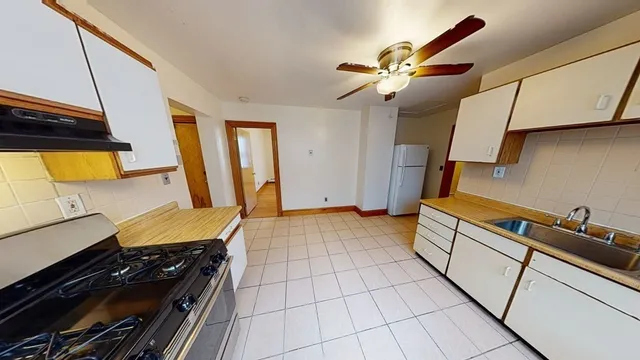 a kitchen with a sink appliances and cabinets