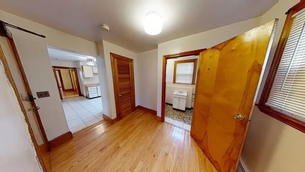 wooden floor in an empty room with a mirror