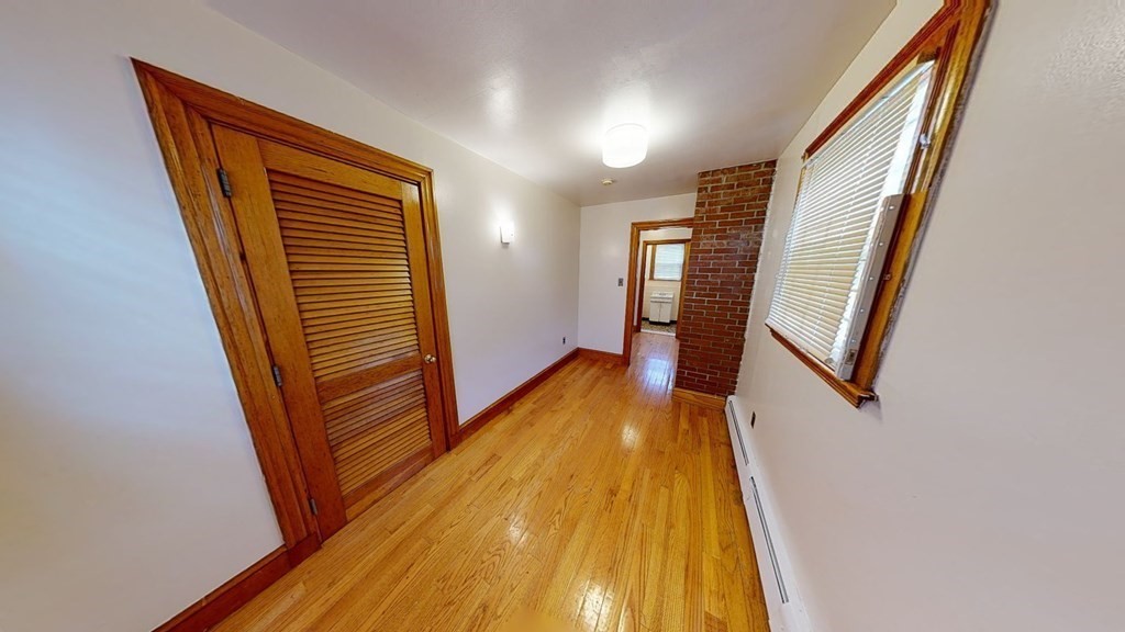 1 Normandy Street, Unit 3 Boston, MA 02121 - Photo 10 of 33 a view of a hallway with wooden floor and stairs