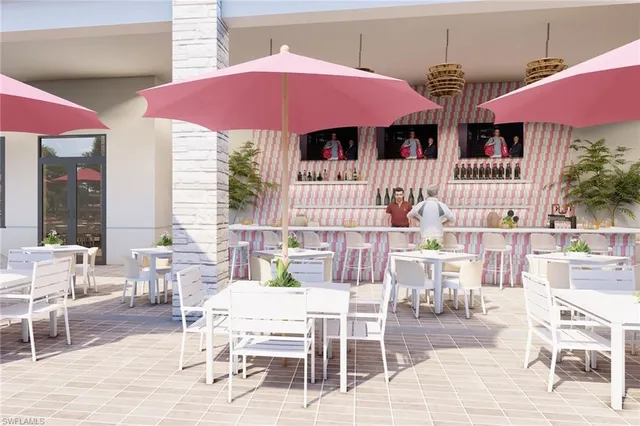 a patio with a table and chairs under an umbrella