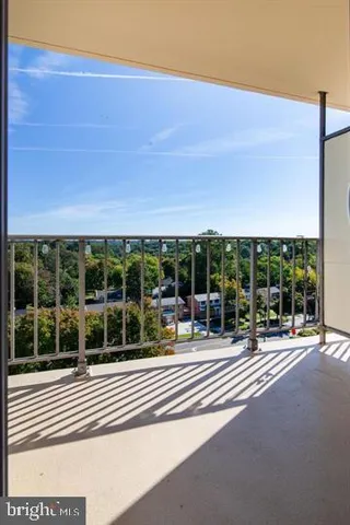 a view of a patio with a table and chairs under an umbrella next to a yard