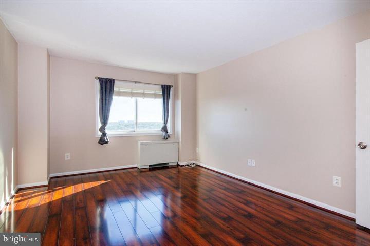 1121 University Boulevard West Silver Spring, MD 20902 - Photo 2 of 20 an empty room with wooden floor and windows