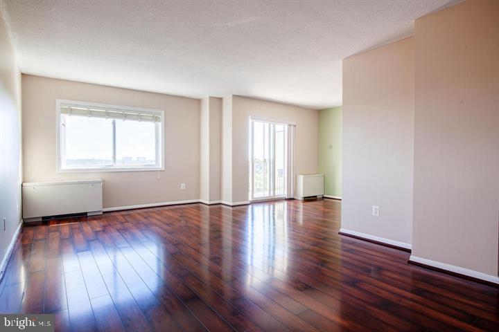 1121 University Boulevard West Silver Spring, MD 20902 - Photo 6 of 20 an empty room with wooden floor and windows