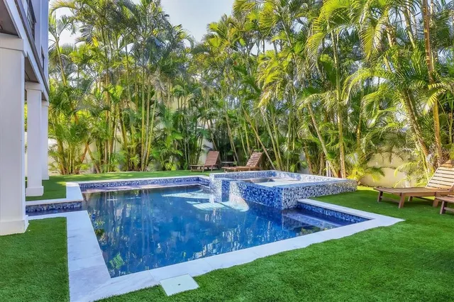 a view of a backyard with swimming pool