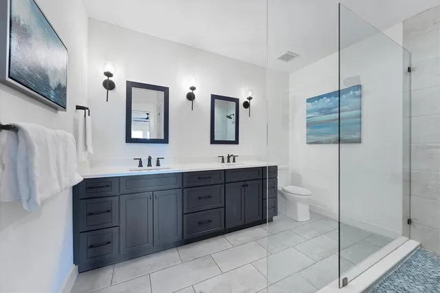 a bathroom with a sink a toilet and a shower