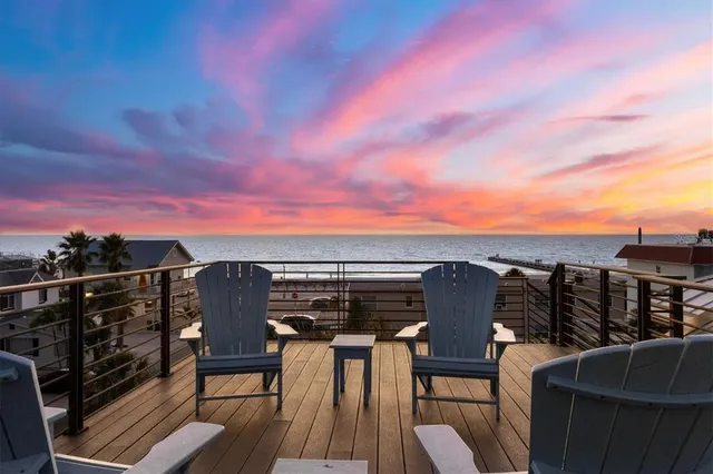 a view of roof deck with wooden floor and city view