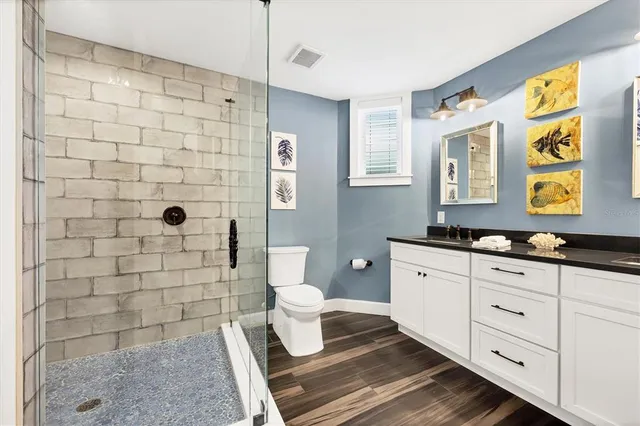 a bedroom with a large bed a chandelier and closet