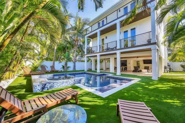 a view of swimming pool with outdoor seating and a garden
