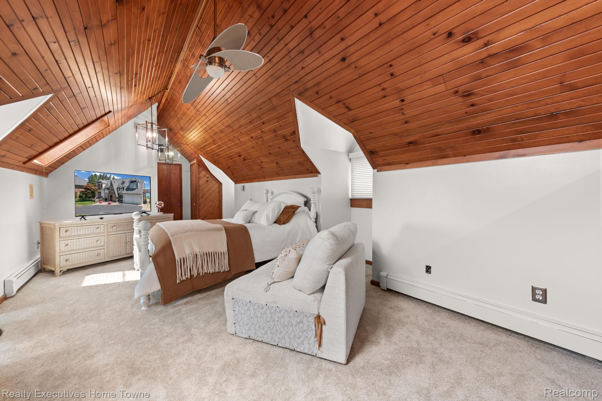 8308 Lakeshore Road Fort Gratiot, MI 48059 - Photo 70 of 79 Vaulted wood-paneled ceiling with a central ceiling fan