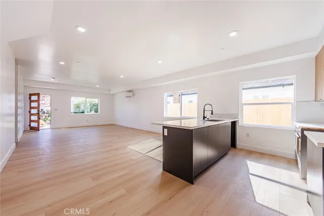 a view of a workspace room with wooden floor and windows