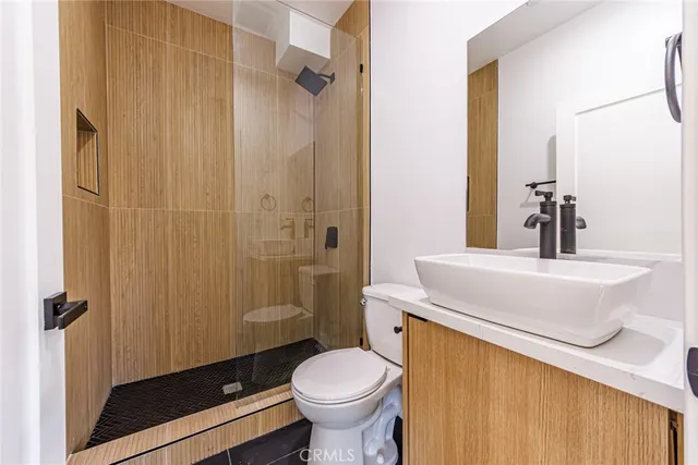 a bathroom with a sink toilet and shower