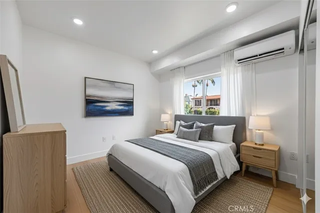 a bedroom with a large bed and a painting on the wall