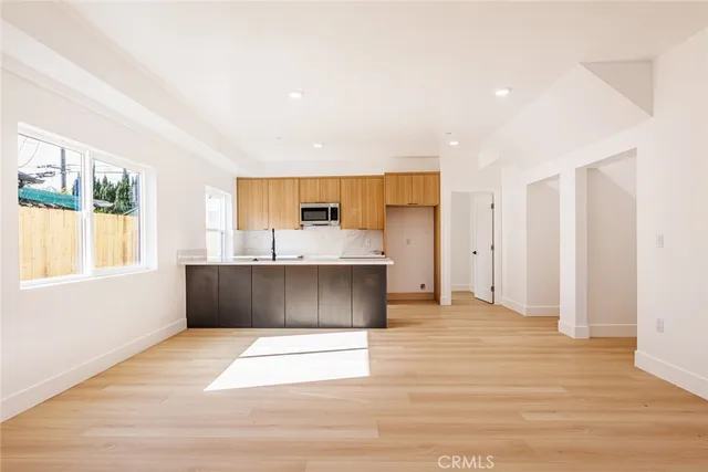 a view of kitchen with stainless steel appliances cabinets and outdoor space