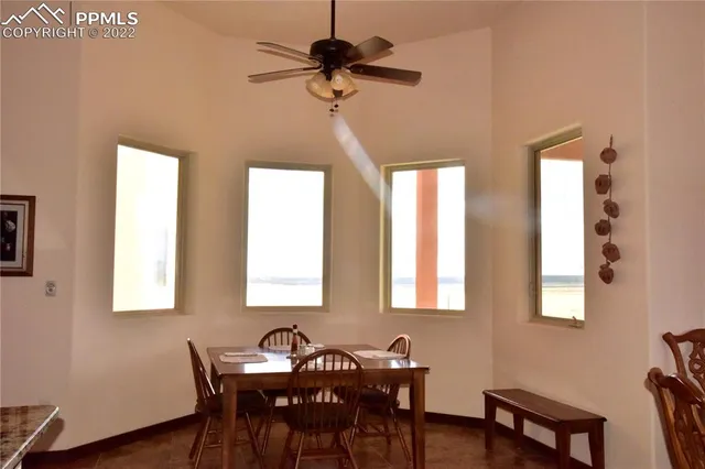 a view of a dining room with furniture and a chandelier