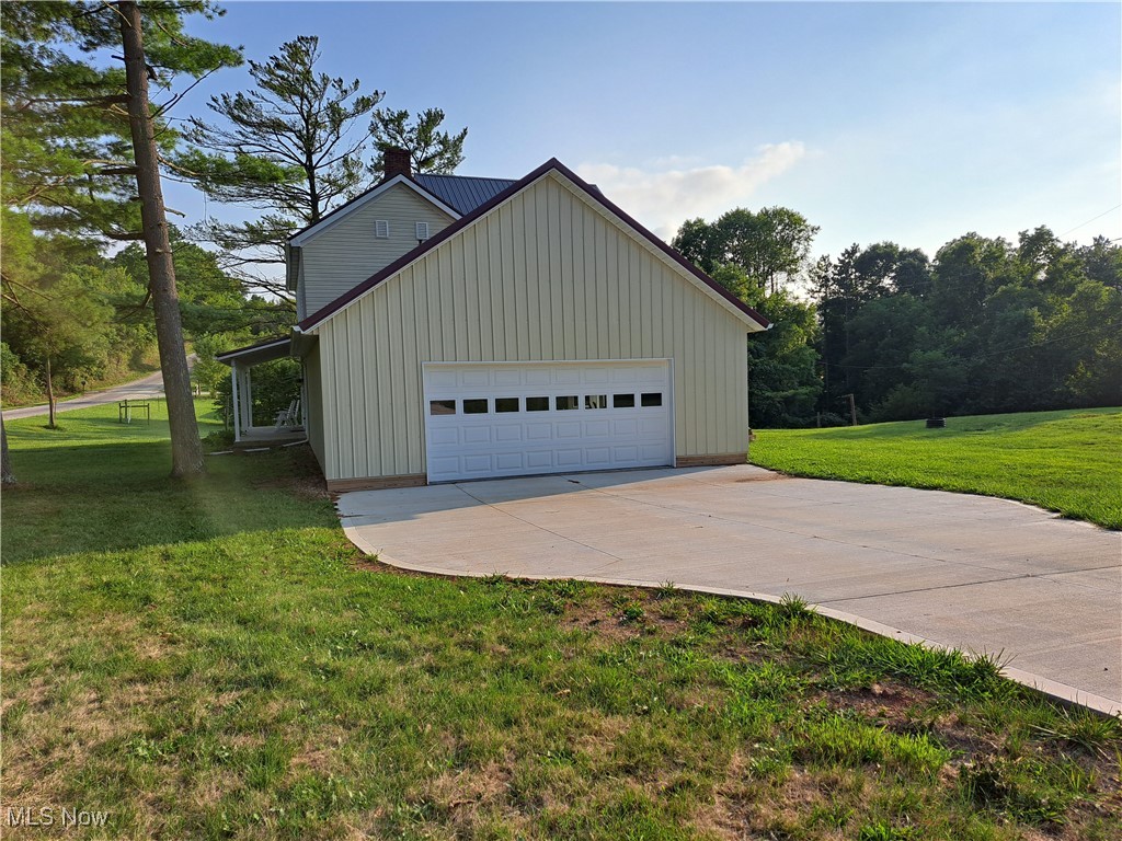 49197 John Tomcho Road Cumberland, OH 43732 - Photo 3 of 50 Garage with a lawn