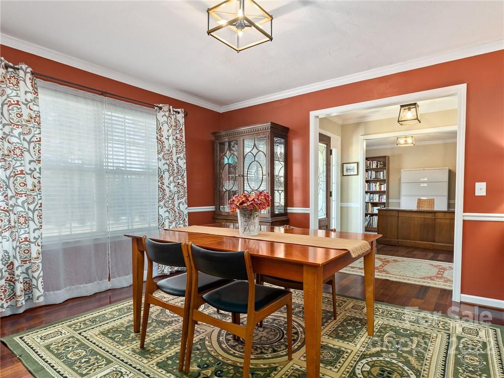 1085 Hooper Creek Road Tryon, NC 28782 - Photo 15 of 34 a view of a dining room with furniture window and wooden floor