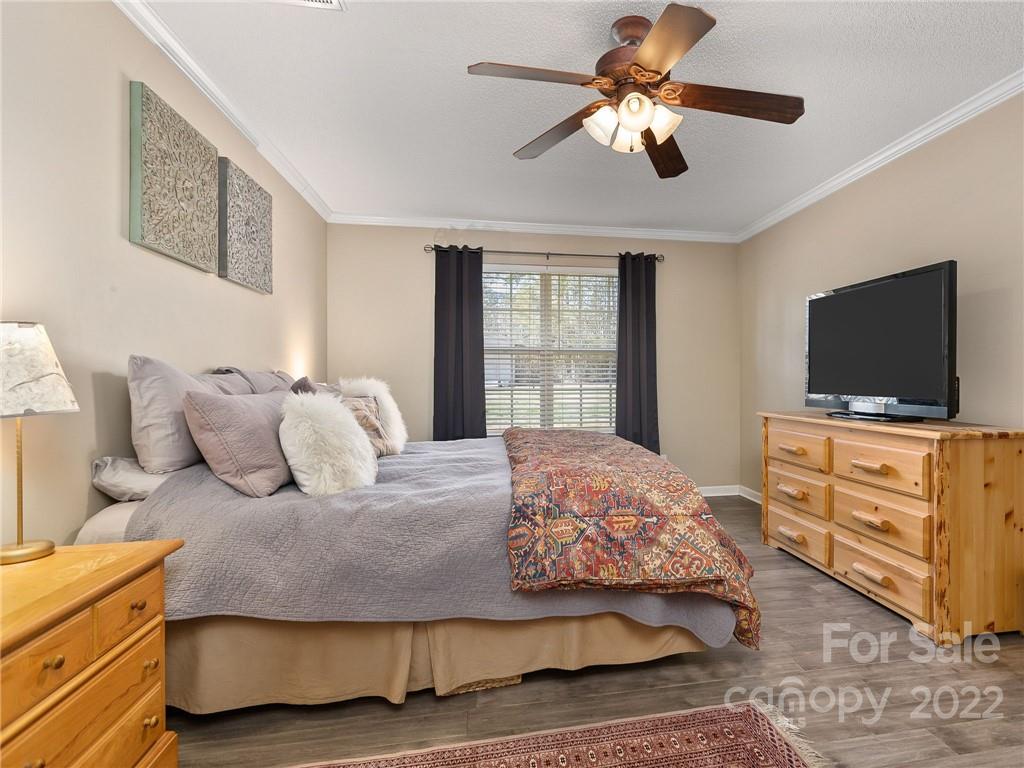 1085 Hooper Creek Road Tryon, NC 28782 - Photo 16 of 34 a bedroom with a bed and a flat screen tv