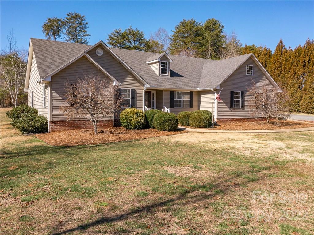 1085 Hooper Creek Road Tryon, NC 28782 - Photo 2 of 34 a front view of a house with a yard