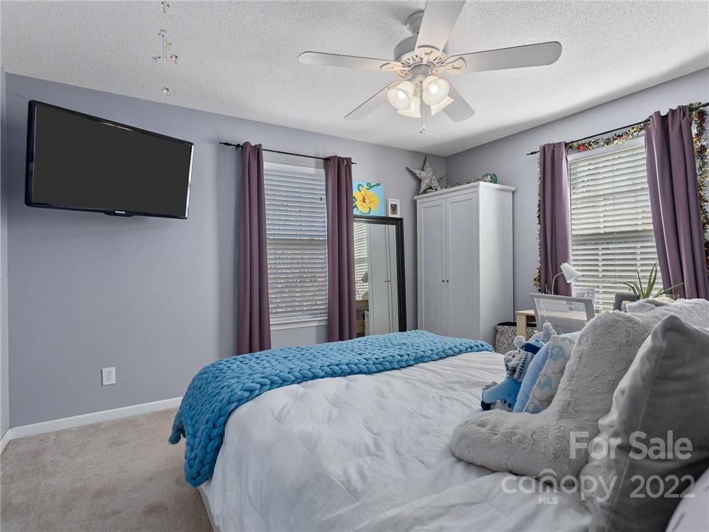 1085 Hooper Creek Road Tryon, NC 28782 - Photo 25 of 34 a bedroom with a large bed and a flat screen tv