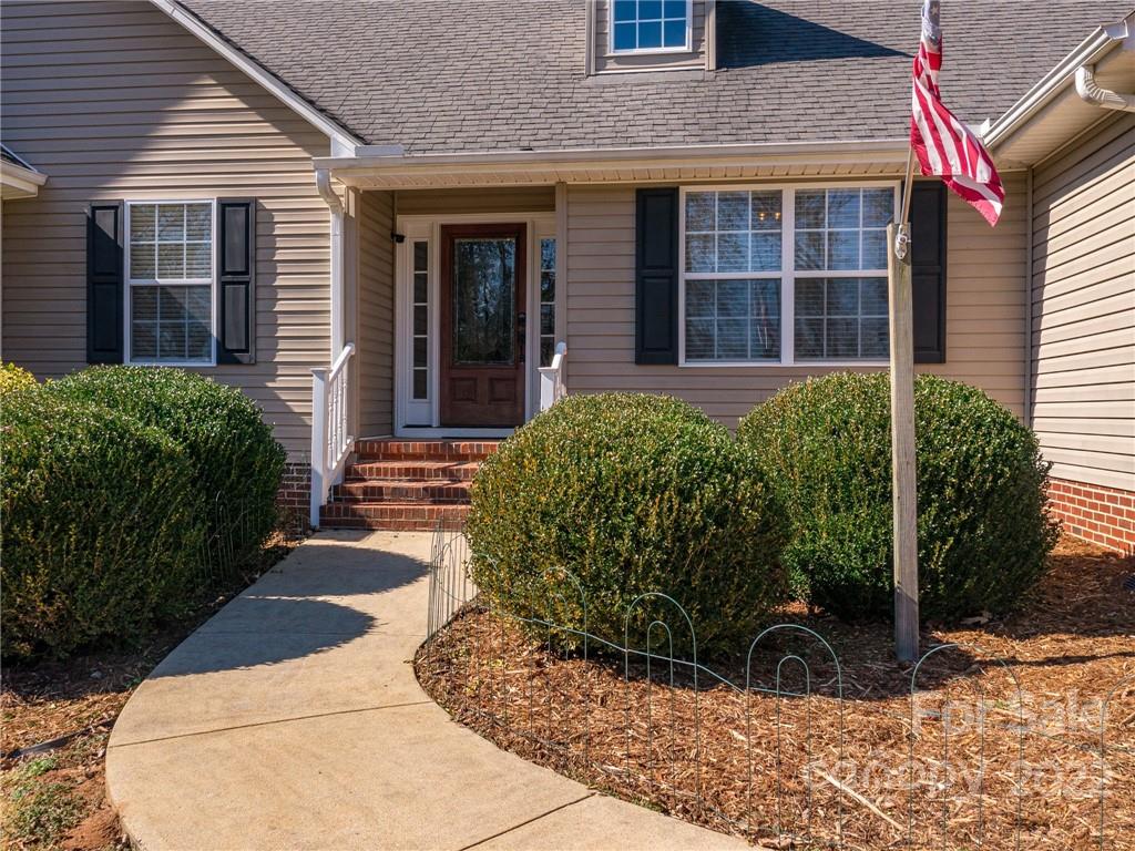 1085 Hooper Creek Road Tryon, NC 28782 - Photo 4 of 34 a front view of a house with garden