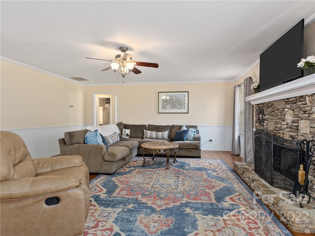 1085 Hooper Creek Road Tryon, NC 28782 - Photo 8 of 34 a living room with furniture a fireplace and a flat screen tv