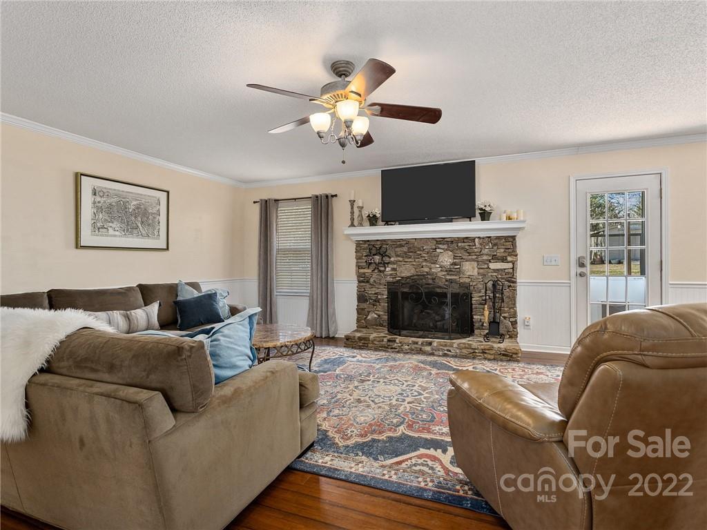 1085 Hooper Creek Road Tryon, NC 28782 - Photo 10 of 34 a living room with furniture a fireplace and a flat screen tv