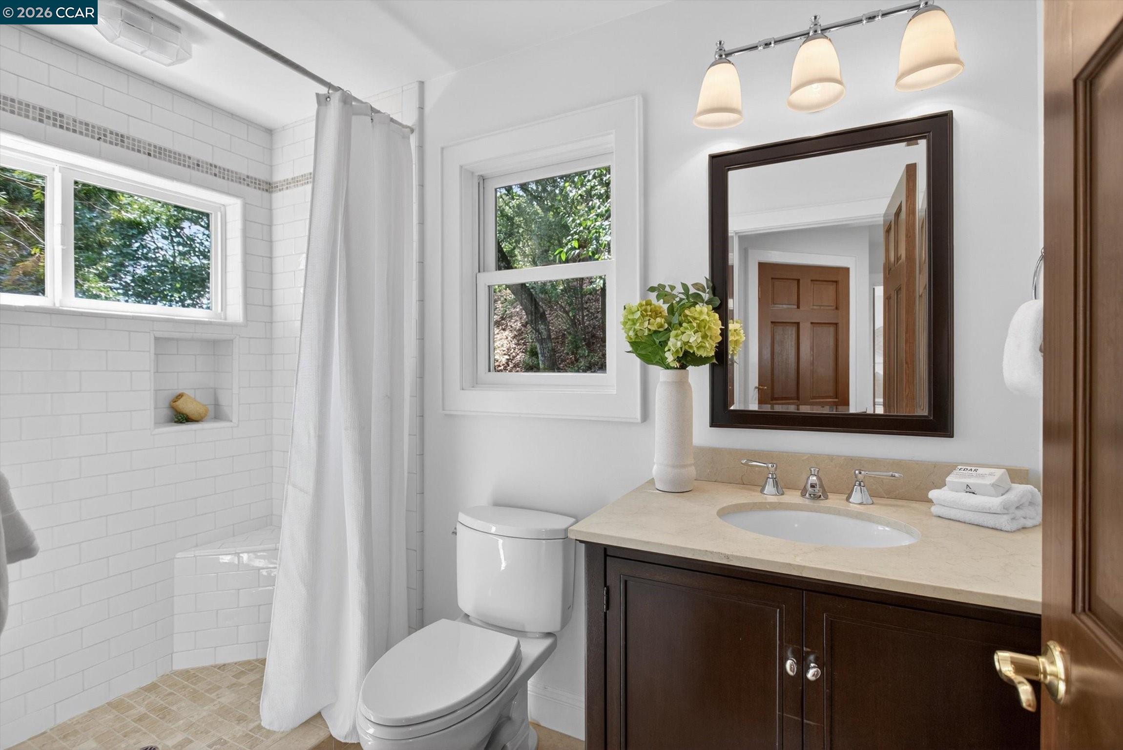 4105 Coralee Lane Lafayette, CA 94549 - Photo 34 of 43 a bathroom with a granite countertop toilet a sink a mirror and a window