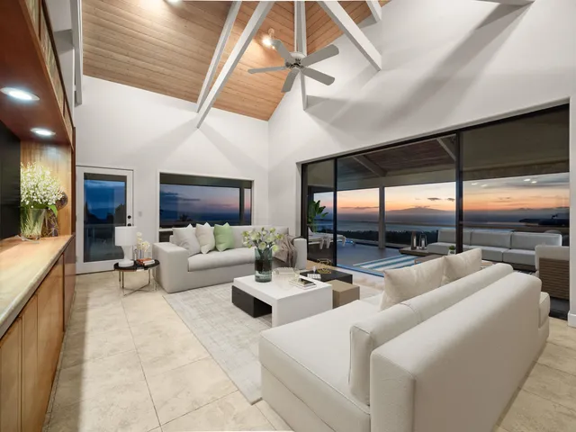 a living room with furniture and a floor to ceiling window