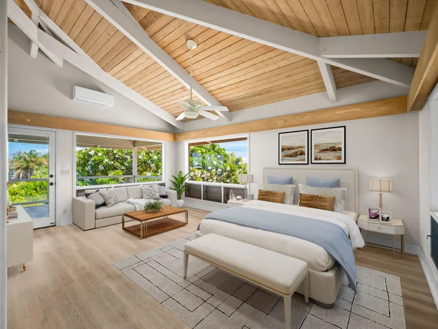 a bedroom with furniture and a large window