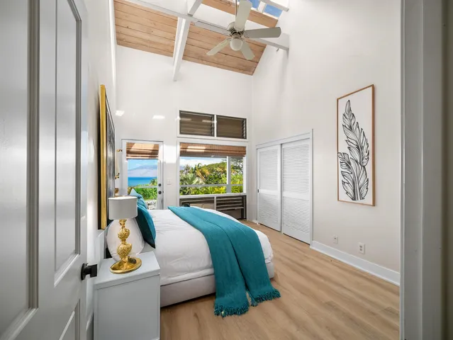 a bedroom with bed and balcony