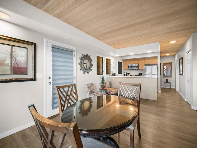 a view of a dining room with furniture and wooden floor