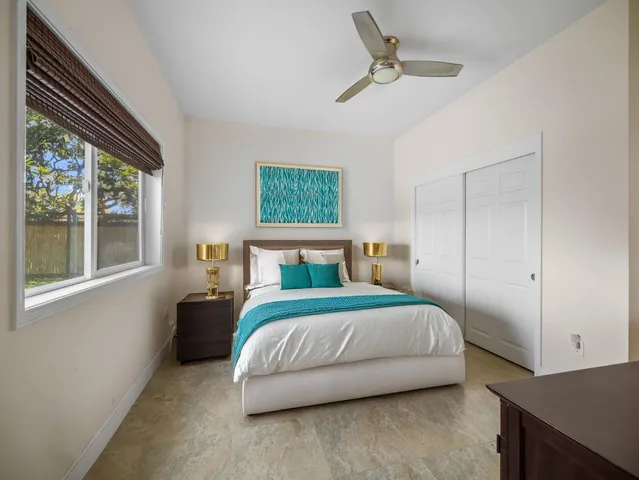 a bedroom with a large bed and a window