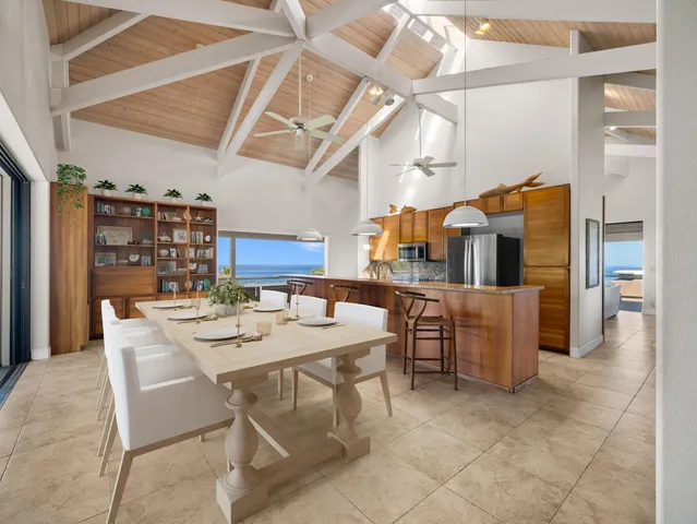 a dining room with a wooden table and chairs
