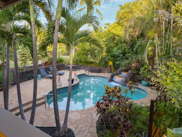 a view of a backyard with sitting area