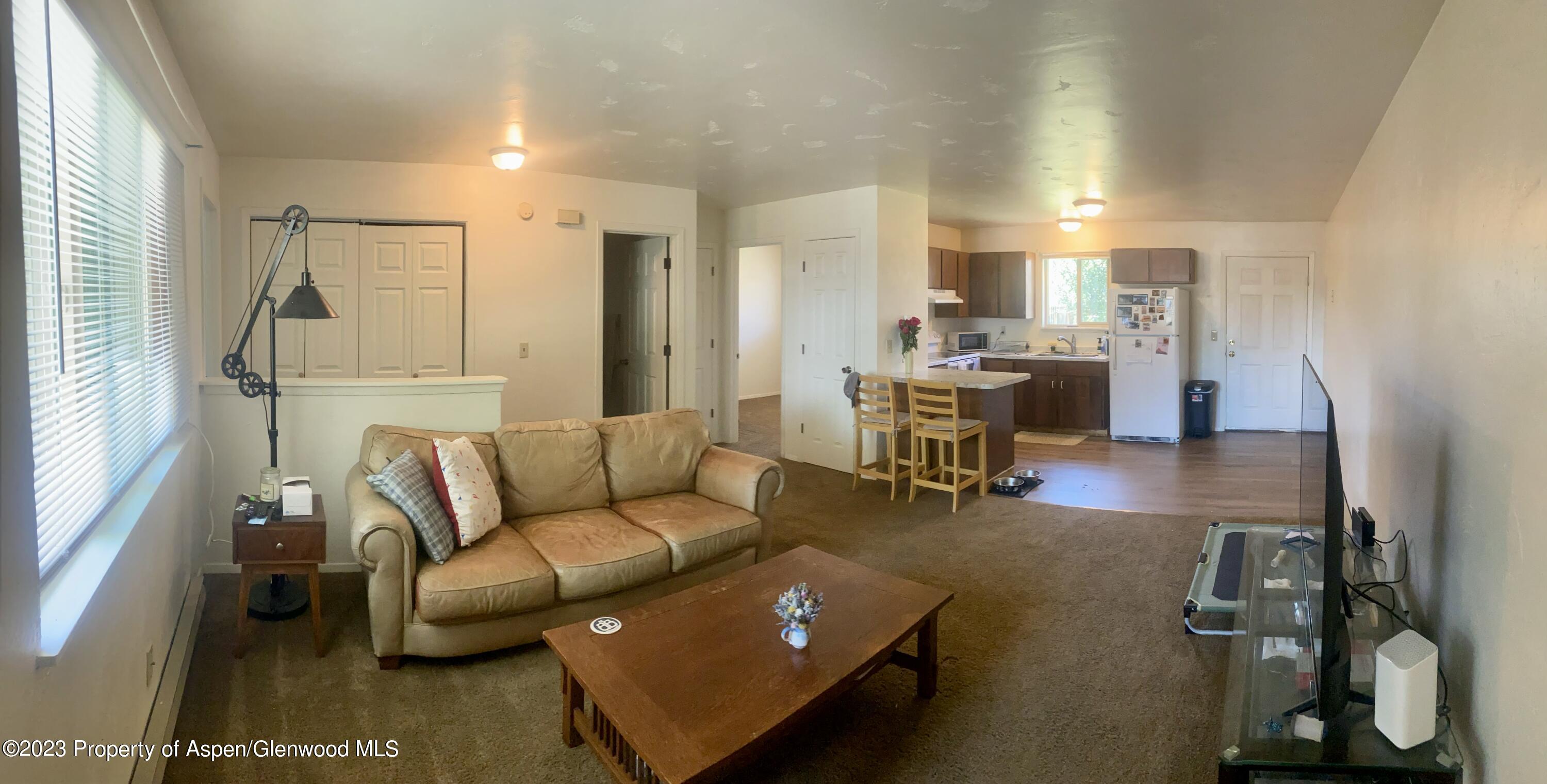 2415 West Avenue Rifle, CO 81650 - Photo 5 of 9 a living room with furniture and a table
