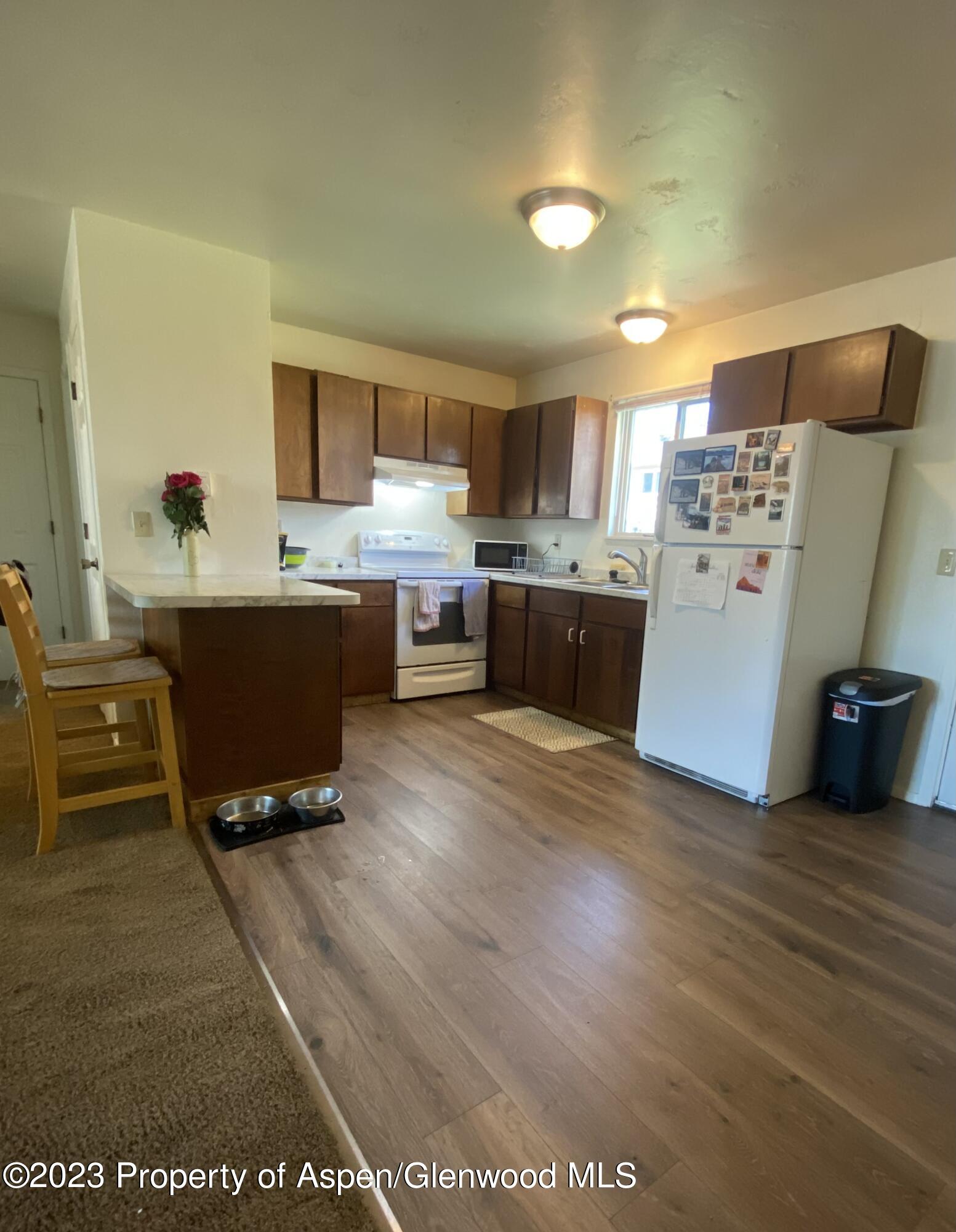 2415 West Avenue Rifle, CO 81650 - Photo 6 of 9 a room with wooden floor and furniture