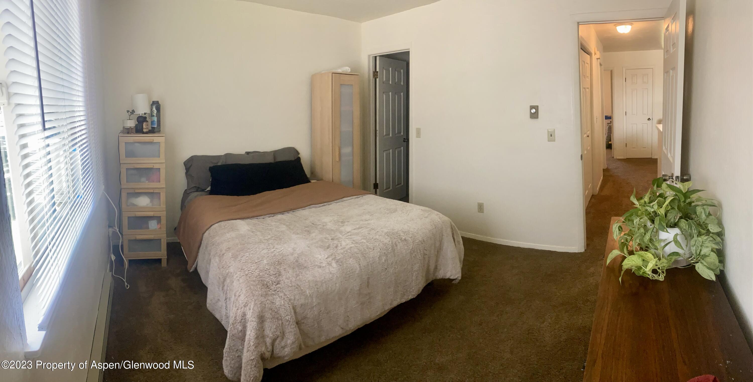 2415 West Avenue Rifle, CO 81650 - Photo 7 of 9 a bed sitting in a bedroom next to a window