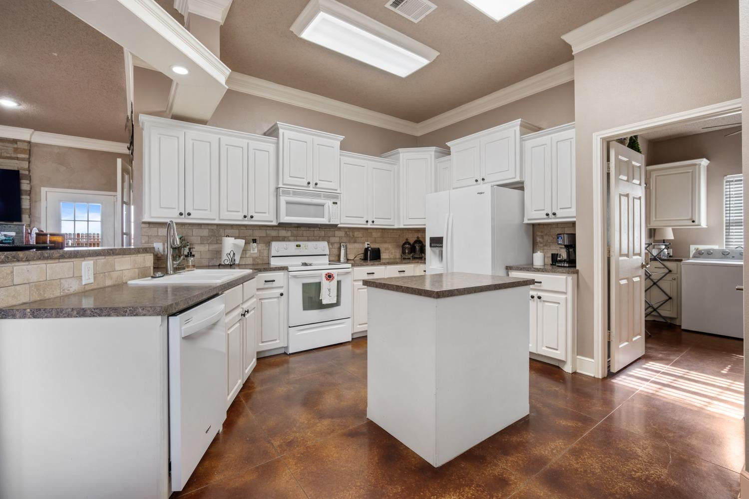6487 East Fm 41 Ropesville, TX 79358 - Photo 21 of 33 a kitchen with granite countertop a sink stainless steel appliances and white cabinets