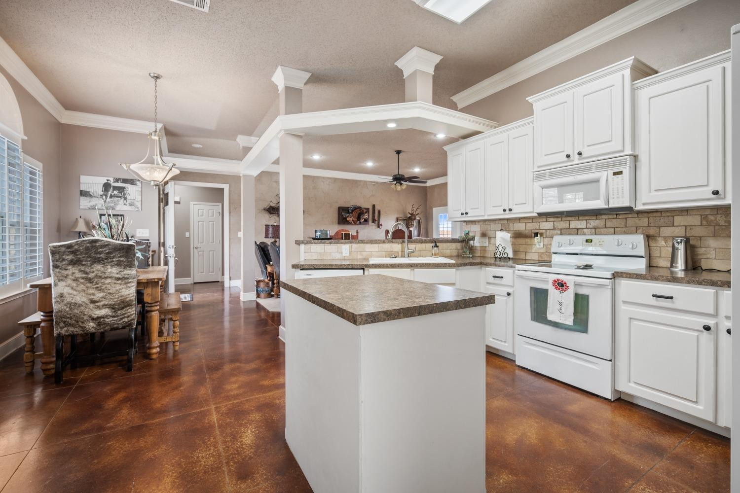 6487 East Fm 41 Ropesville, TX 79358 - Photo 23 of 33 a kitchen with stainless steel appliances kitchen island granite countertop a table chairs and a refrigerator