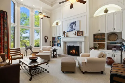 a dining room with furniture a chandelier and window